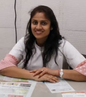 Young man in blue shirt talking on phone in modern office environment